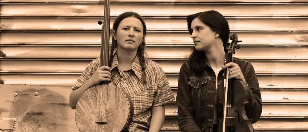 Two women with a banjo and a fiddle